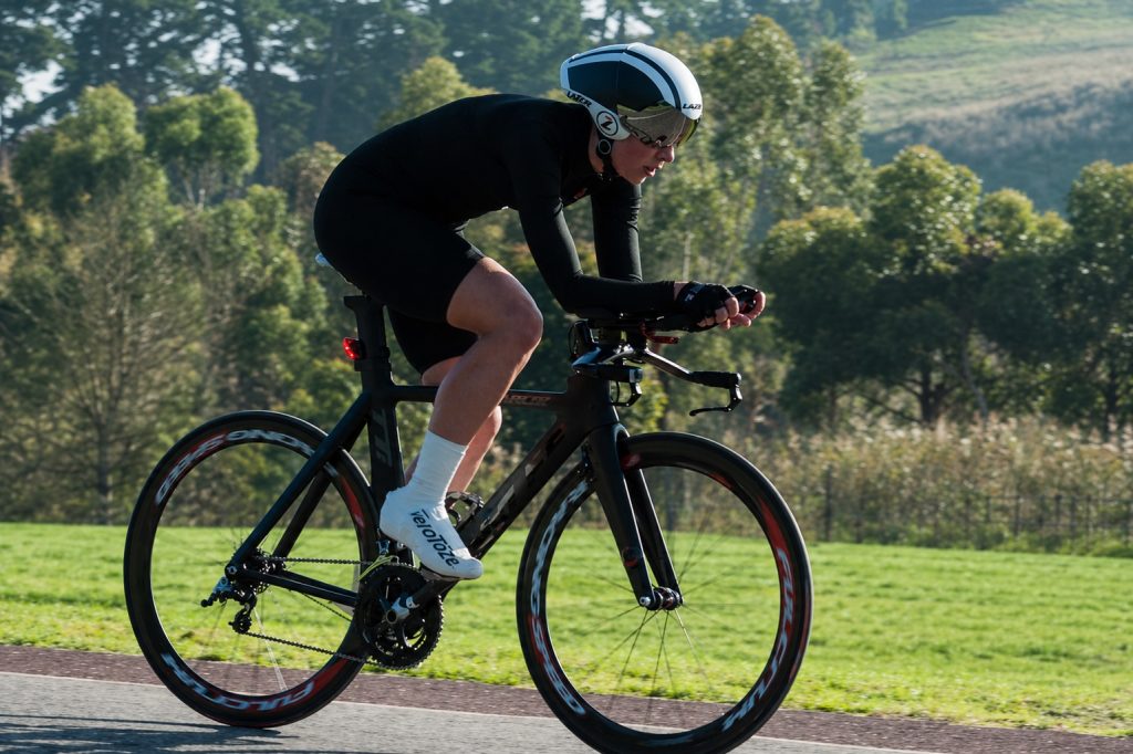 Cyclist riding in a time trial position, focused and working under pressure during performance