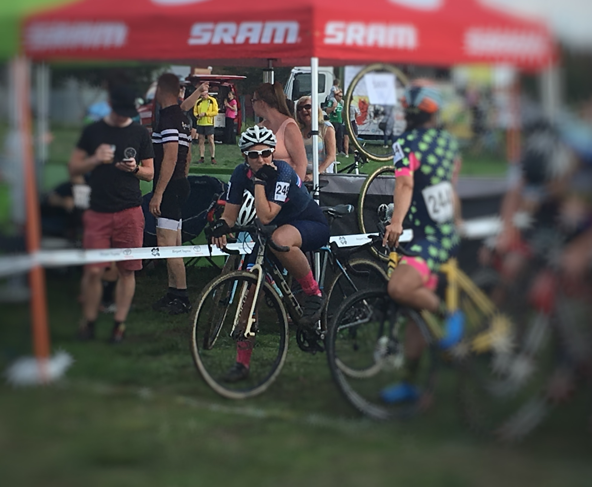 A cyclist pausing on the start line to take a breath before the race starts — managing performance anxiety through calm preparation.