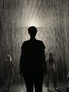Silhouette of a person standing under a spotlight — representing anticipation and focus before performing.