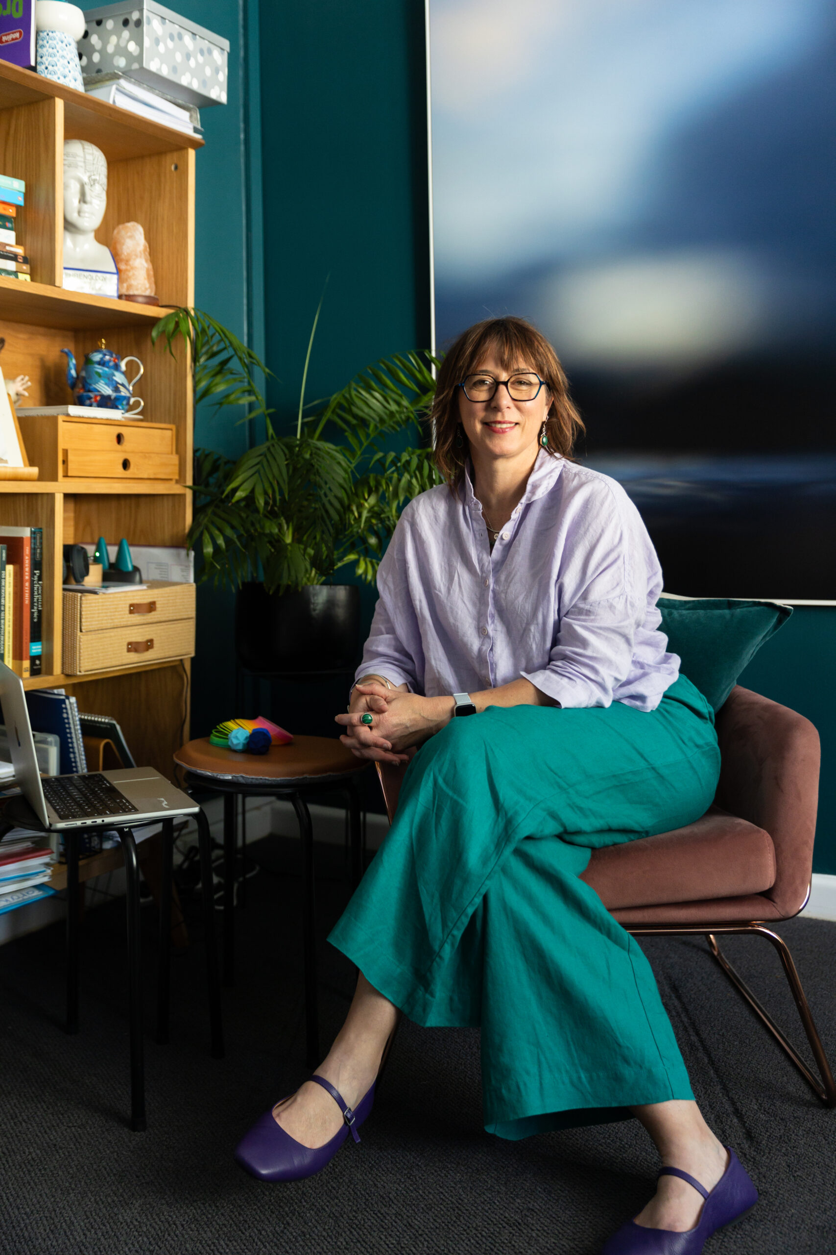 Psychologist Nonie Carr seated in her therapy room at Enhance Life Psychology, offering a warm and supportive space for counselling and therapy.