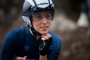 Performance psychologist Melbourne with cycling helmet reflecting lived experience of performance environments