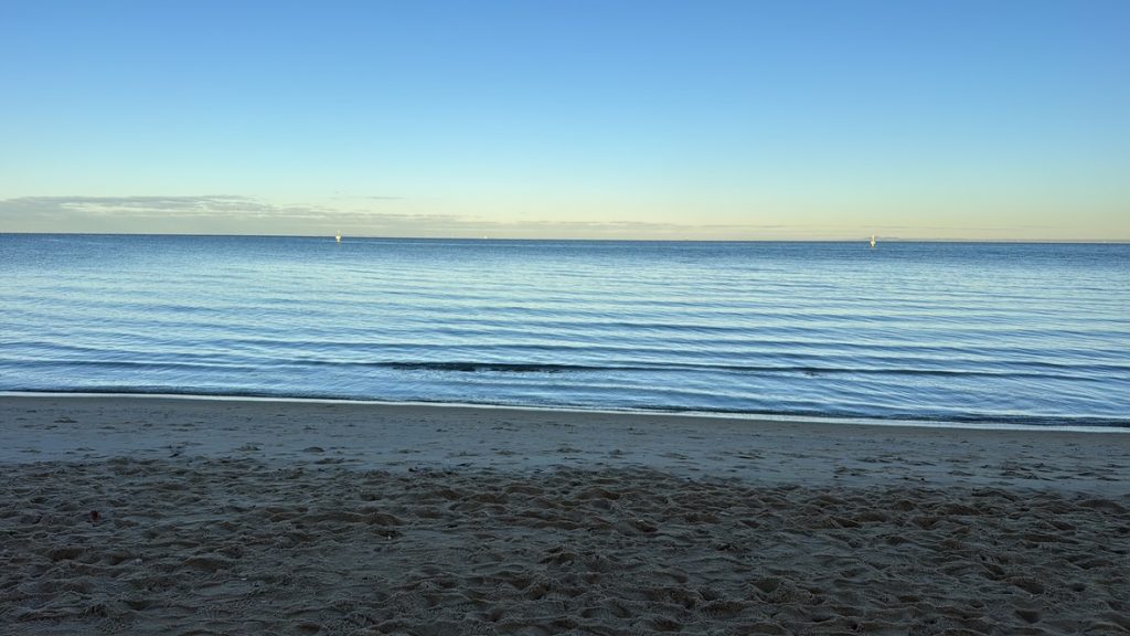 Calm ocean horizon with gentle waves representing widening attention and emotional regulation