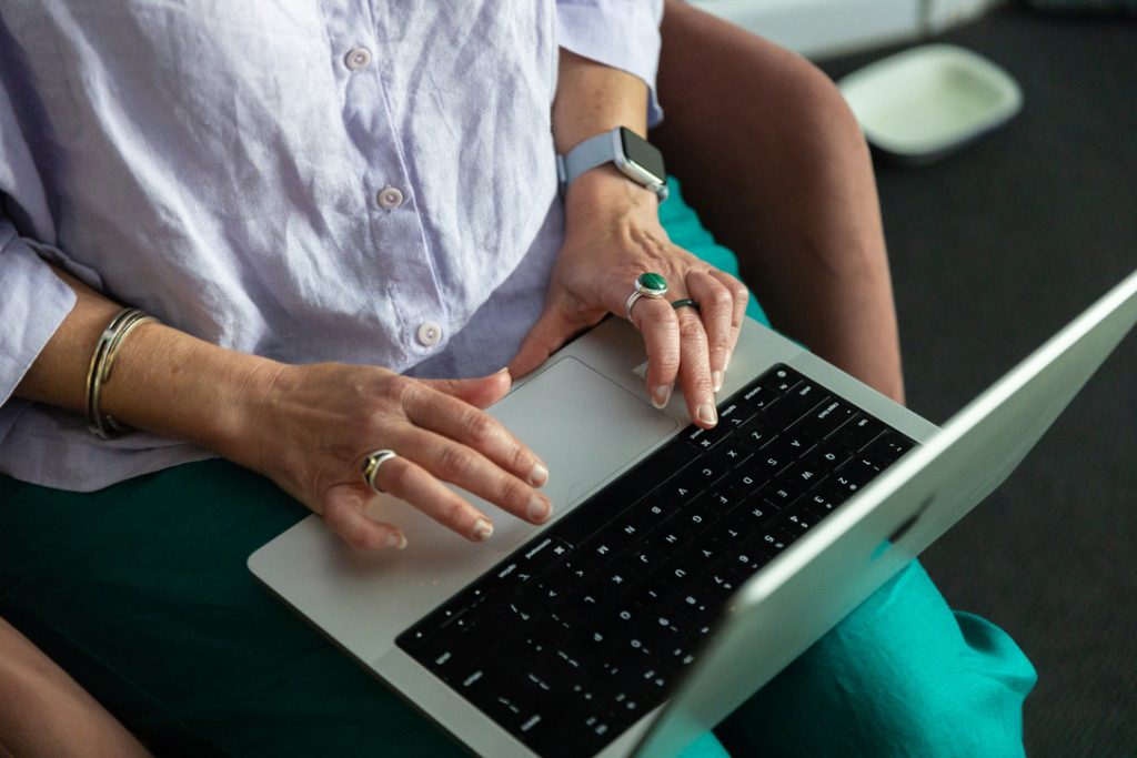 Close-up of hands typing on a laptop, representing digital thinking and interaction with technology
