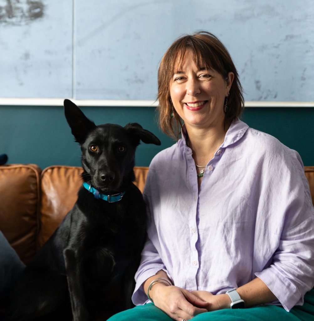 onie Carr, Counselling Psychologist, with her black Kelpie Bindi in her Albert Park psychology practice