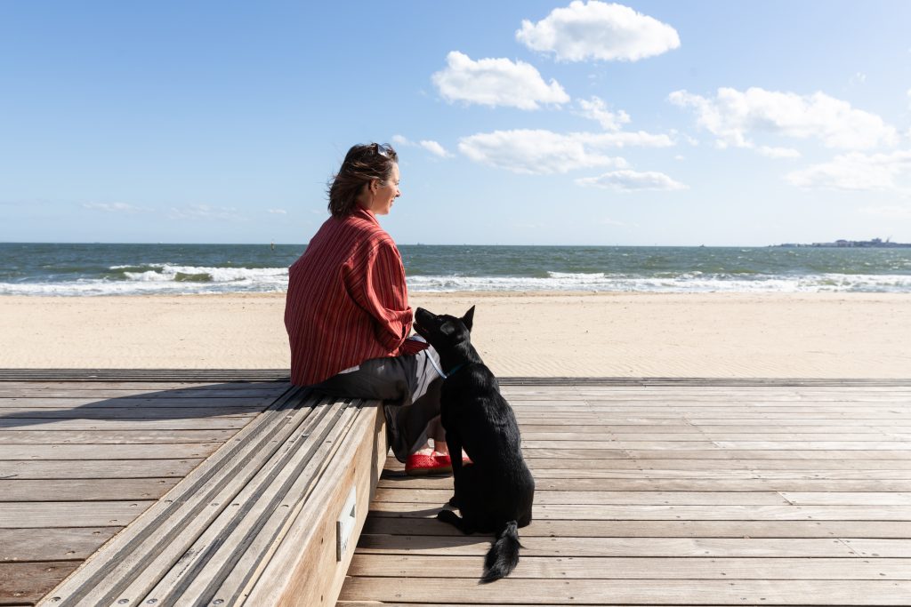 onie Carr, Counselling Psychologist, with Bindi at the beach near Albert Park
